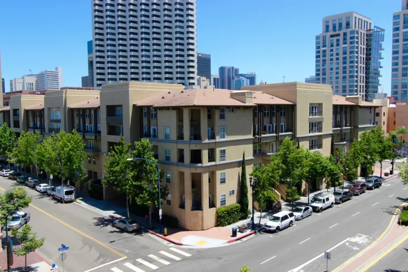 A sunny day in the citywalk community of Downtown San Diego California. An apartment building with high rises behind it