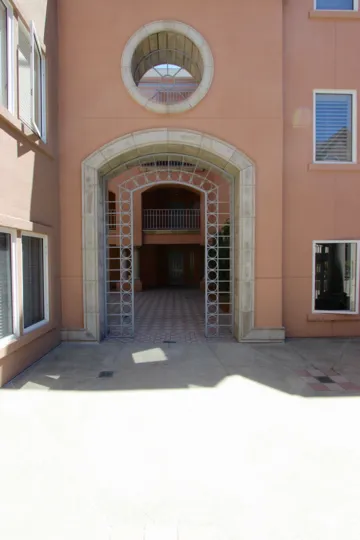 A round glass-less window sits above a stone archway at Columbia Place