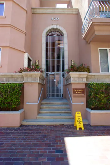 A pink building with a gated front door that would be at home in South Beach