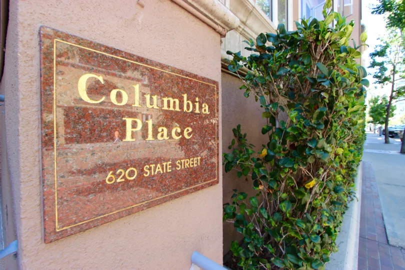 the columbia place in the street has some planet and trees