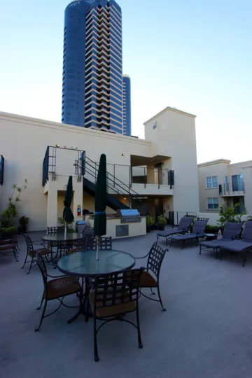 A tall building on a clear day of Crown Bay in San Diego, CA.