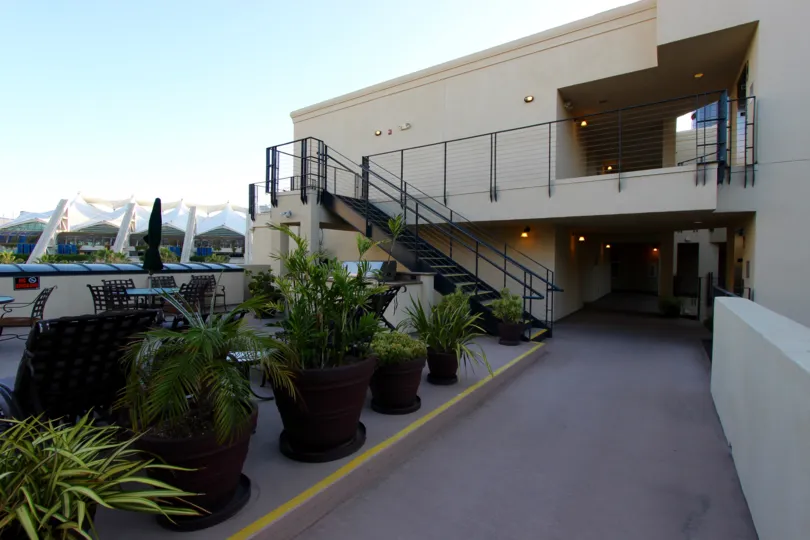 Potted plants lining a sidewalk near condos at Crown Bay in Downtown San Diego CA
