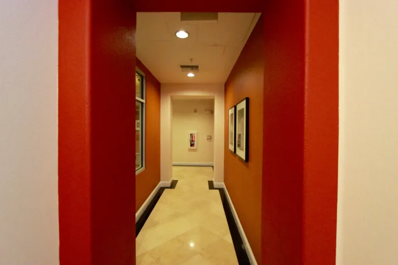 A bright red hallway with wall art at Crown Bay in downtown San Diego, CA.