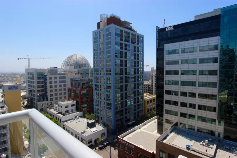 On a balcony in Diamond Terrace overlooking many buildings on a sunny day.