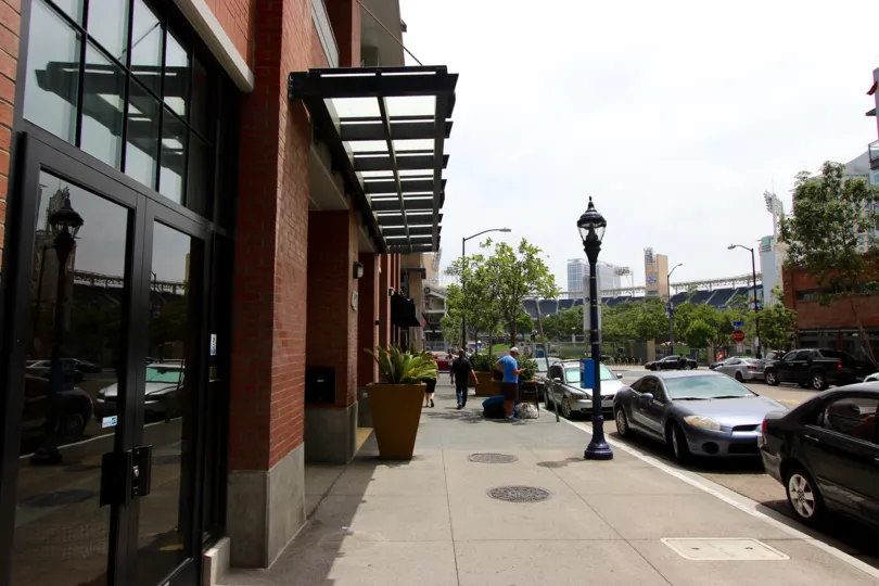Sidewalk in front of a tall brick building at Diamond Terrace CA