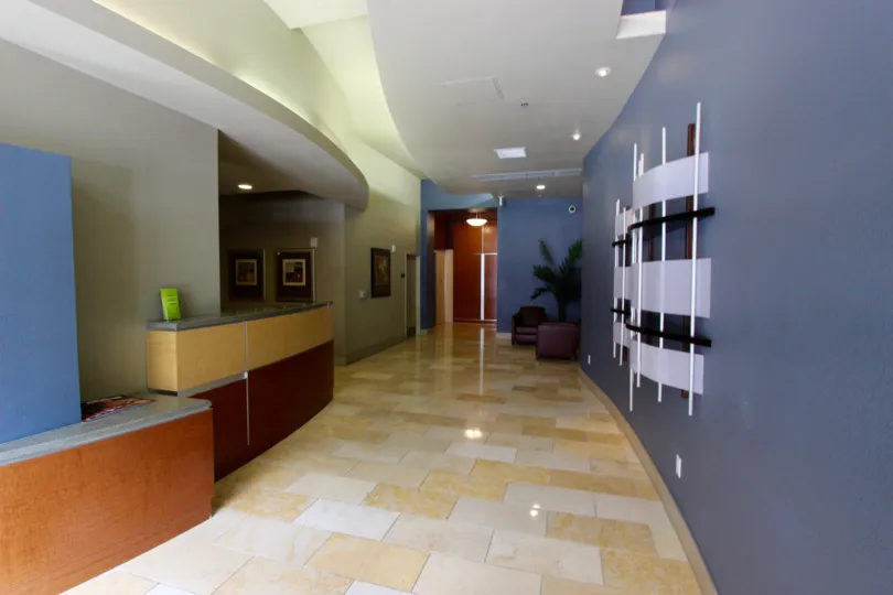 Marble tiled walkway with track lighting inside Diamond Terrace in Downtown San Diego CA