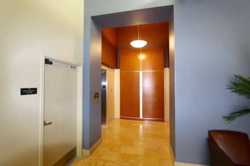 Lobby with an elevator and hanging light at Diamond Terrace in Downtown San Diego CA
