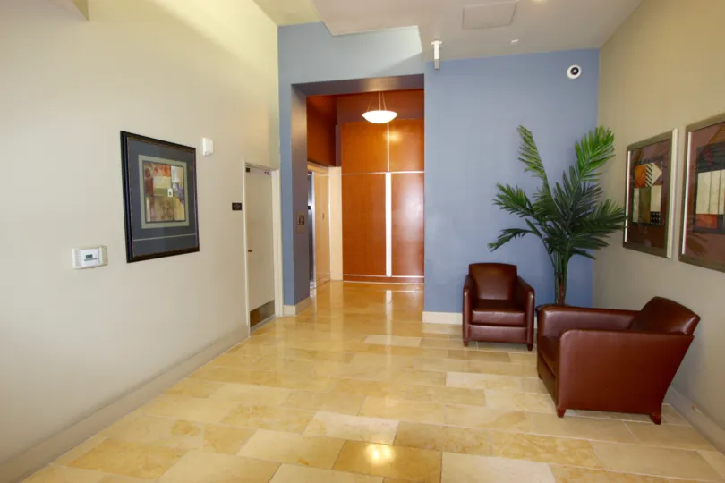 Marble tile floor in lobby with brown furniture at Diamond Terrace in Downtown San Diego CA