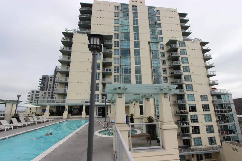 A man swims alone in the pool at the Discovery condos.