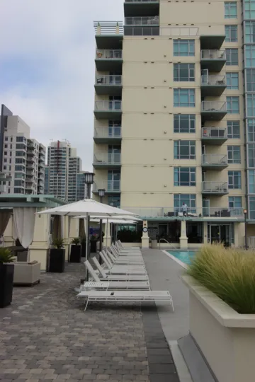 Old fashioned looking apartment building with a pool.