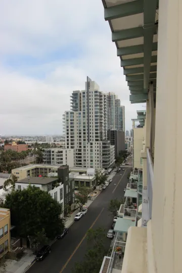 Balcony Street view of the Discovery Condos Downtown San Diego California with parked cars by sidewalks
