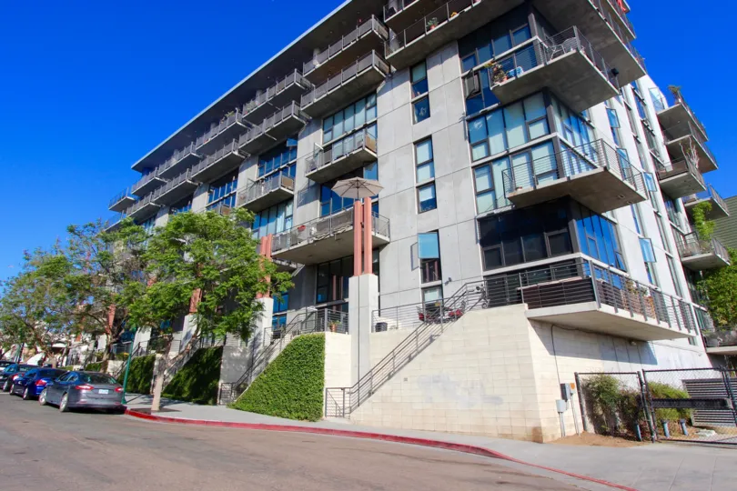 The beautiful apartment is located in the roadside of the community DOMA and which has trees and cars there.