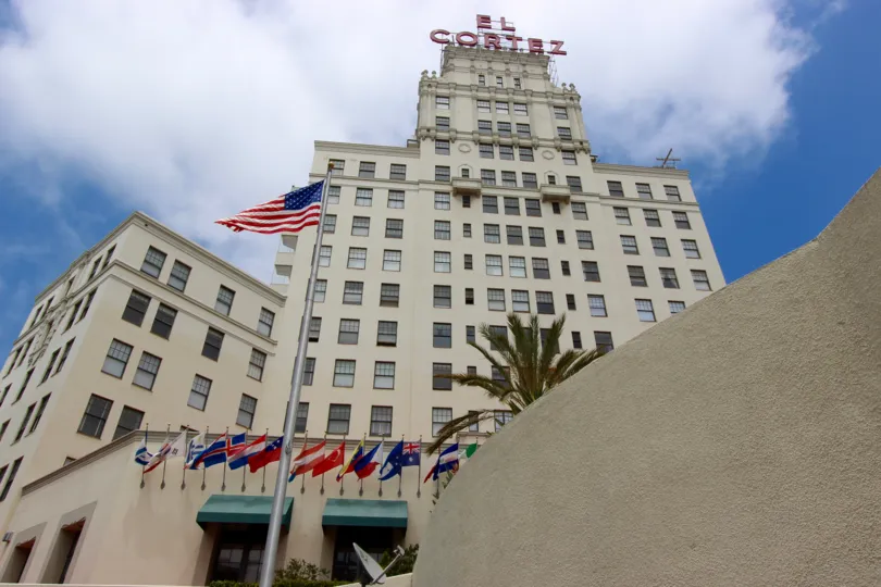Tall white building with a neon sign at El Cortez in San Diego CA