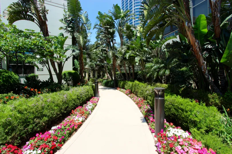 building have trees and beatiful garden in front in electra