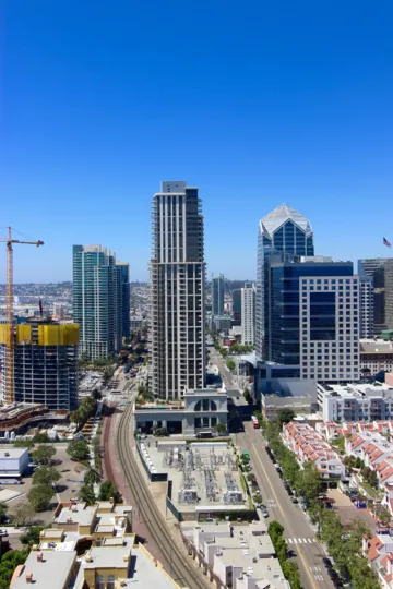 A view of the skyline of the Electra community including condos, high rise offie buildings, interstate, and a crane.