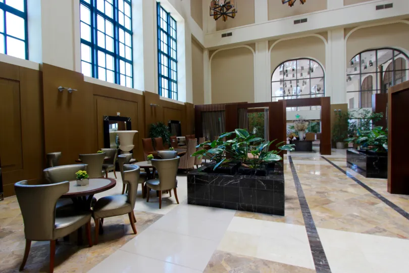 Large room with marble floors filled with furniture inside Electra at Downtown San Diego CA