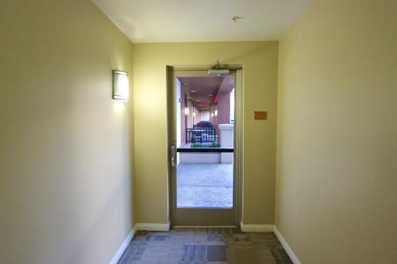 A single wall sconces lights a hallway in the daytime at Gaslamp City Square
