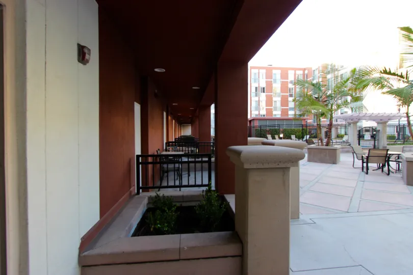 Patio tables sit under a covered area at Gaslamp City Square