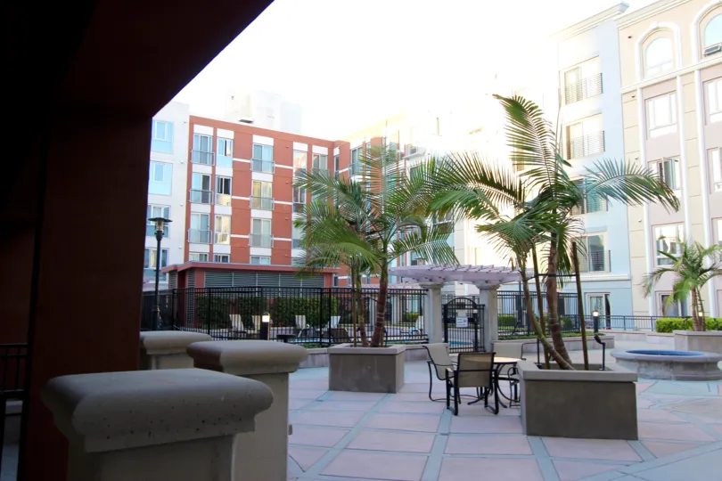 This hotel looks beautiful nearly lot of apartments are there and chairs are there and the coconut trees also there in Gaslamp City Square