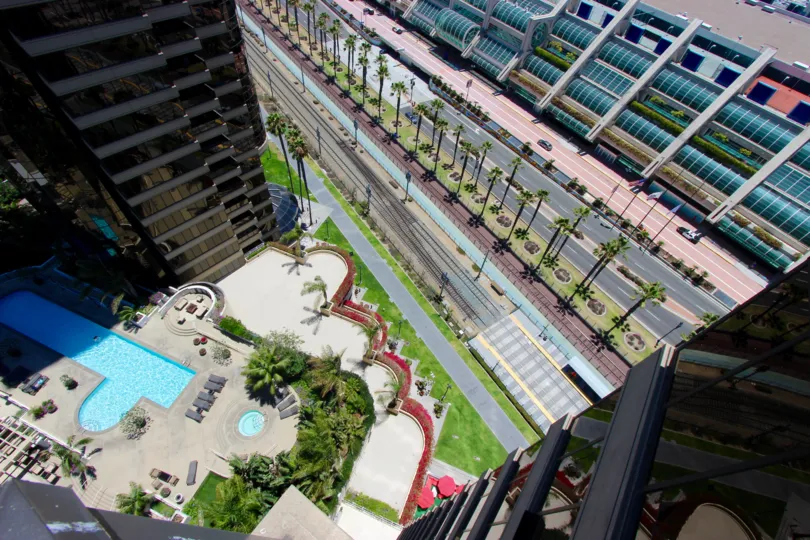 A sunny and radiant day at The Harbor Club with views of the the glistening swimming pool and the gorgeous roadways lined with palm trees.
