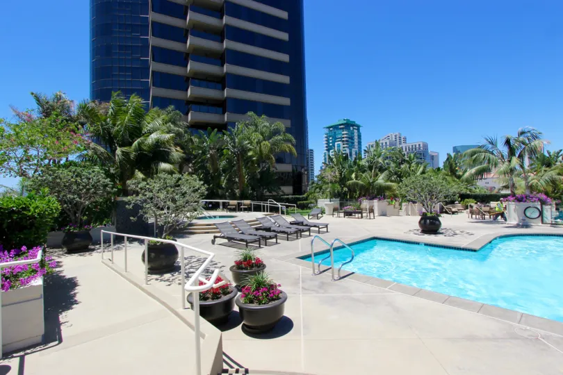 Large crystal blue pool beneath residential units at Harbor Club in Downtown San Diego CA