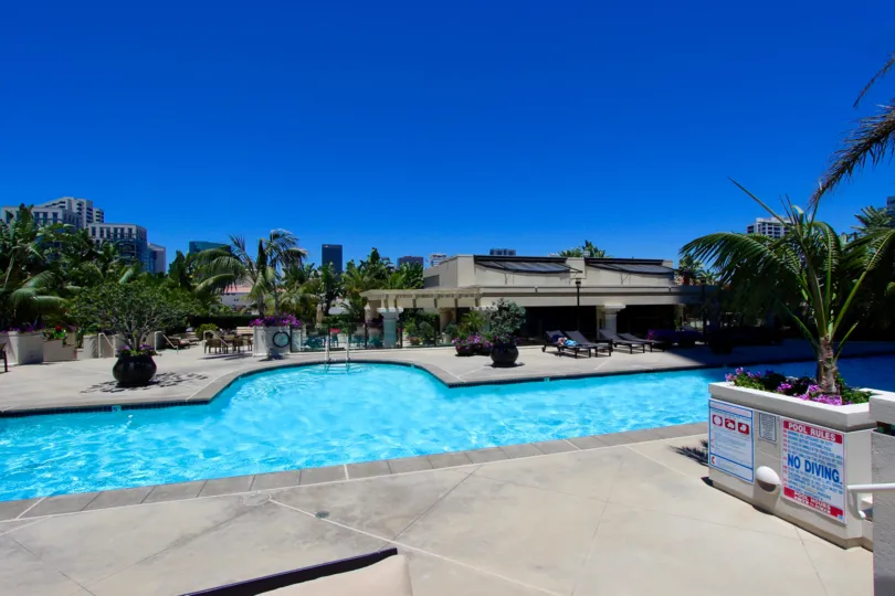 Hat style swimming pool with big flower pots in harbor Club.