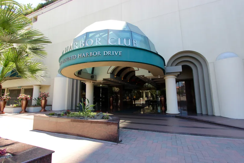 Grand entrance at the Harbor Club with beautiful palm trees