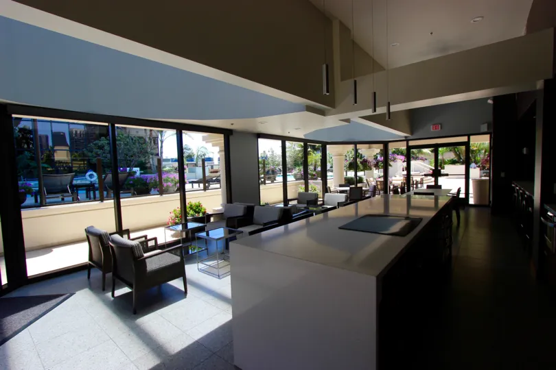 Indoor seating area looking out over outdoor leisure areas of the Harbor Club in San Diego