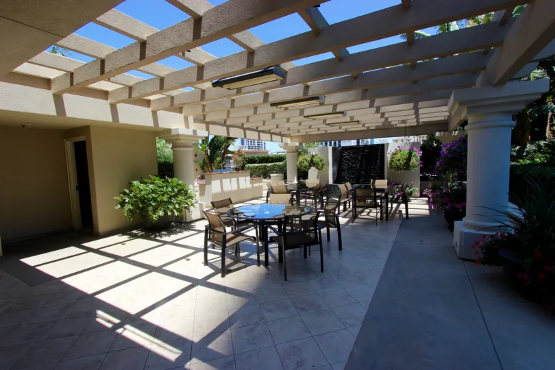 Lattice-covered dining area with hanging plants at Harbor Club in Downtown San Diego, California