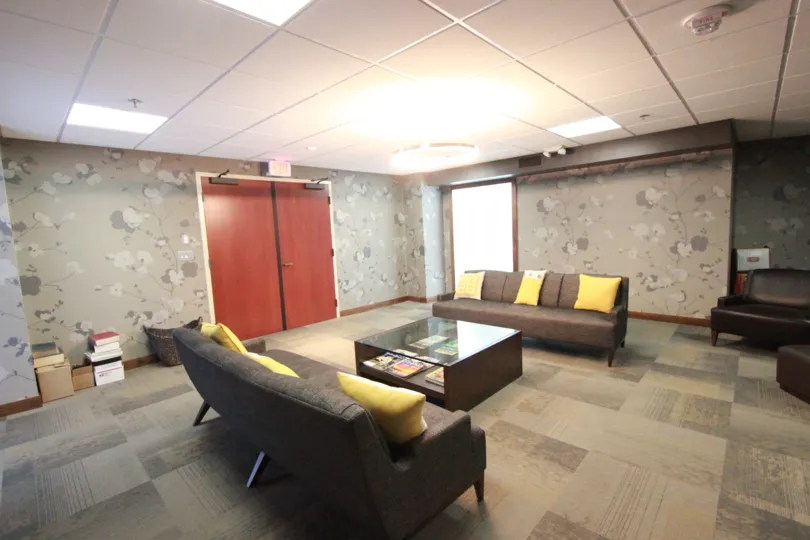 THE HOTEL IN THE HARBOR CLUB WITH SOFAS, PILLOWS, TABLES.