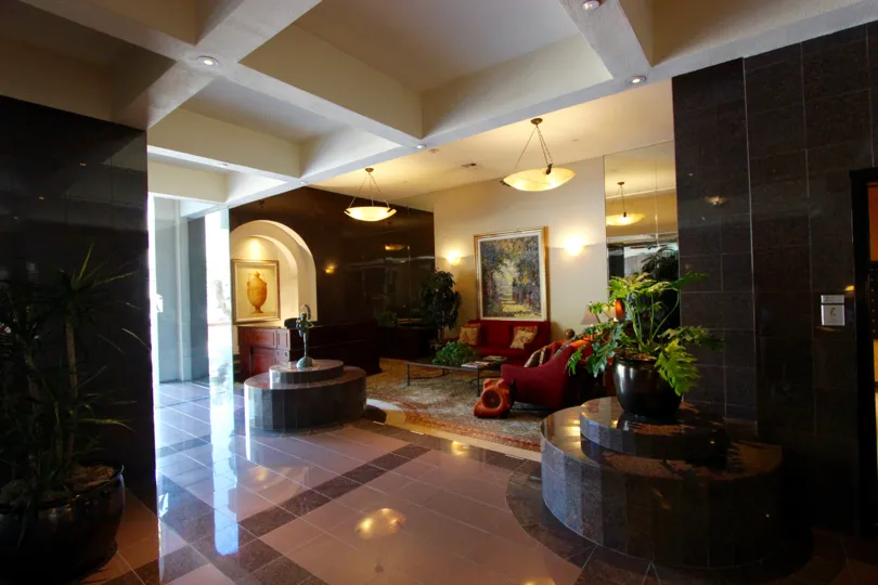Shiny black tiles line the walls near the elevators at Harbor Club