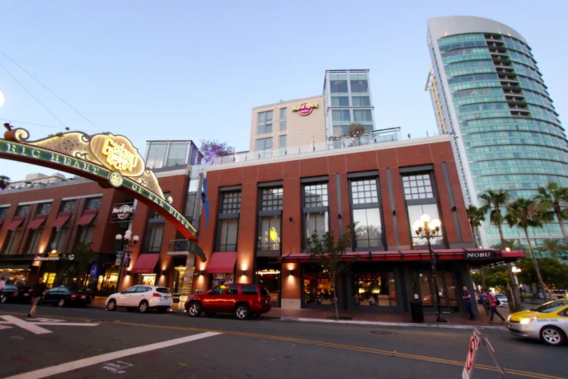 A brightly lit sign sits above the street outside of Hardcock in Downtown San Diego