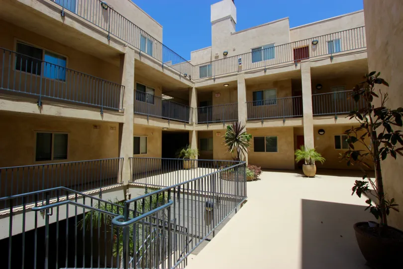 A sunny day in the area of Hawthorn Place, outside, courtyard, balconies, potted plants, stairs
