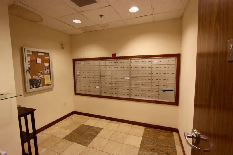 Subdued and simple interior view of the Horizons with mailboxes and noticeboards with muted colors and well-lit clean interiors