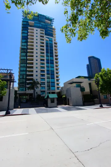 a sunny day with a hotel decorated by trees, with small houses surrounded