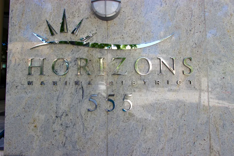 A shiny chrome sign on a marble wall inside Horizons Community in downtown San Diego CA