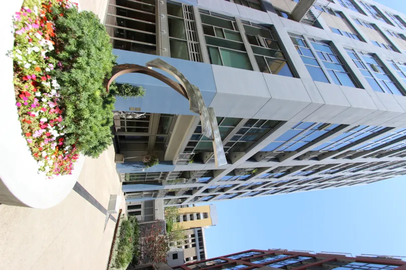 in the suny day there is a building and flowers ! beautifull day