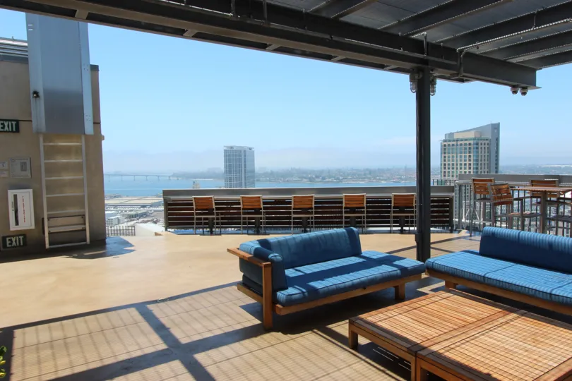 A well lit patio on the roof top of Icon with a view of the city in Downtown SD CA