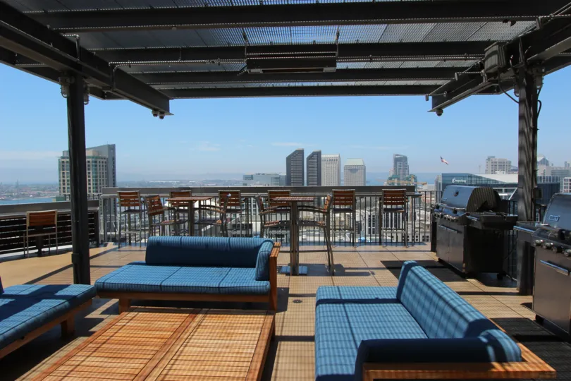 A breath taking view of the city skyline from the roof top patio equipped with grills and outdoor furnishings
