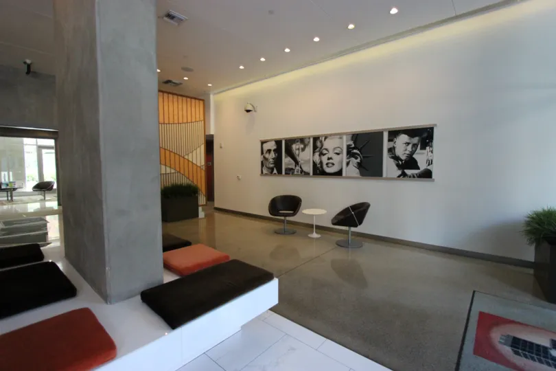 A luxurious well-lit apartment complete with stone floors, modern decor, and black-and-white vintage photos.