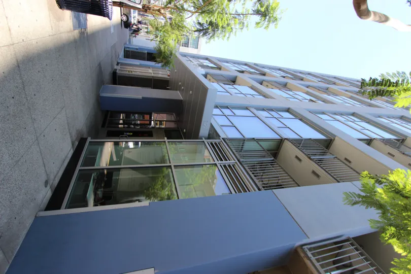 The Icon condo building casts a shadow on the sidewalk in front.