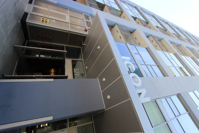 Very modern architecture and building sign with sweeping glass window facade at Icon