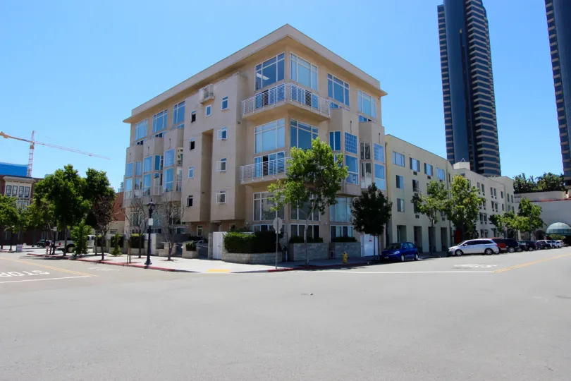 A sunny day in the area of Island Lofts, outside, street, trees, card, parkins spaces, balcony, window