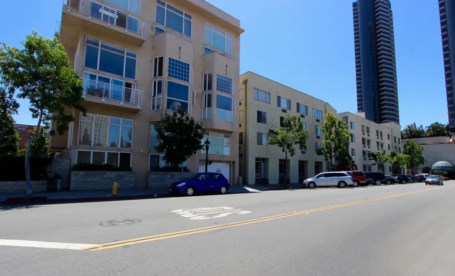 Beautiful light tan townhouses are shining in the mid-day sun in San Diego