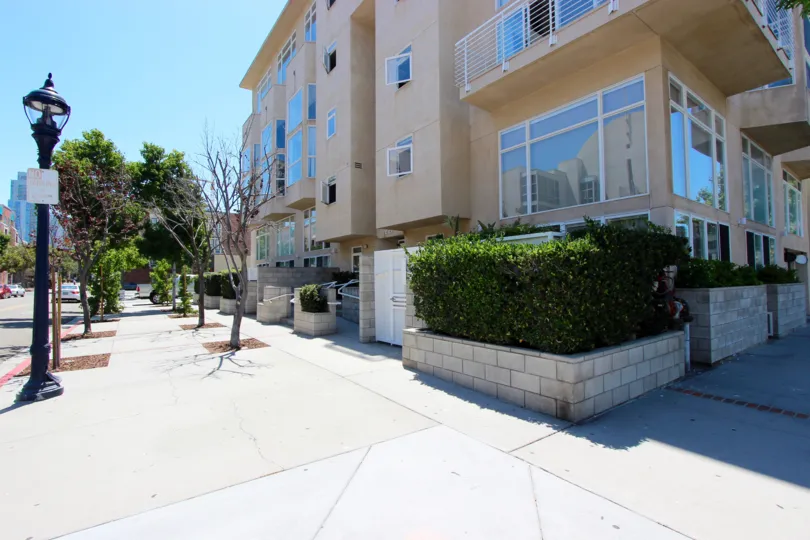 A sunny day outside an apartment building with nice hedges in Downtown San Diego