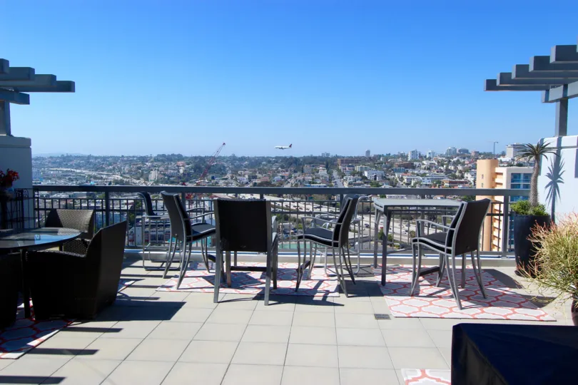 Patio chairs are arranged to look out over the cityscape at LaVita