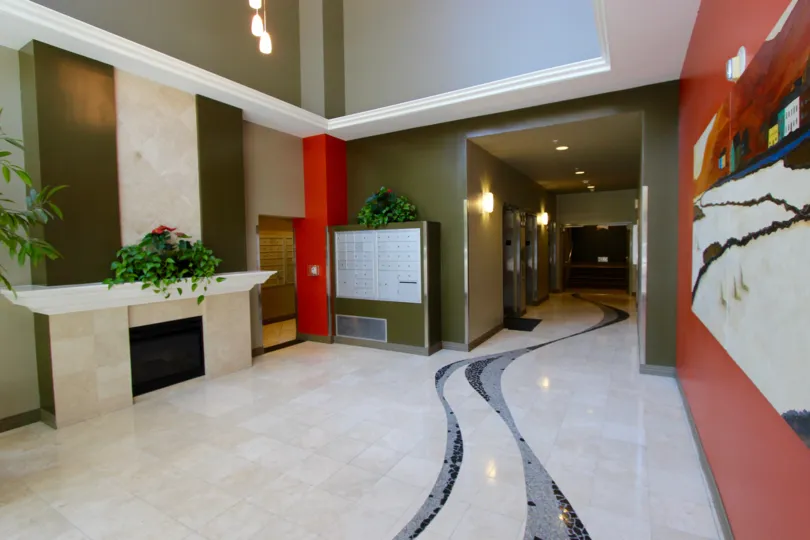 A hallway with white walls and lockers in La Vita neighborhood