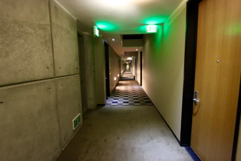 THE HOTEL IN THE M2I WITH ROOMS, AND EXIT WAY, WOODEN DOOR.