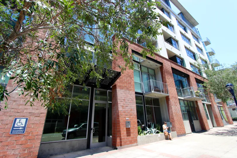 A golden and sunny day at the M2i with a beautiful view of the artsy and modern architecture with bold red-brick exteriors and tree lined street