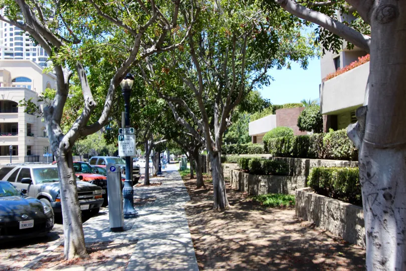 Sodewalk with trees and 2 tiered landscap and street parking Marina Park Downtown San Diego California
